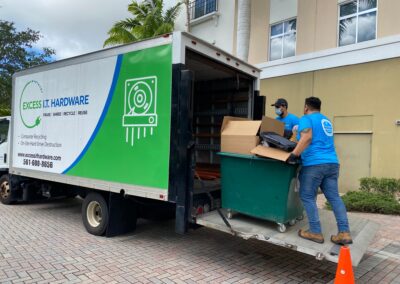 a crew loading a box into a truck